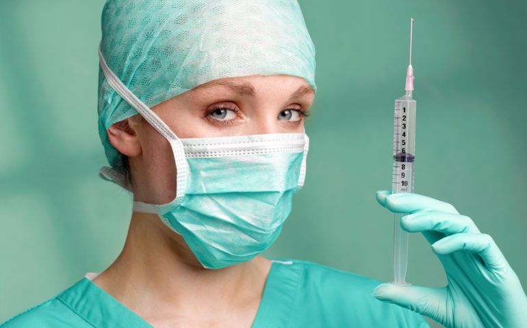 Lady surgeon doctor with syringe