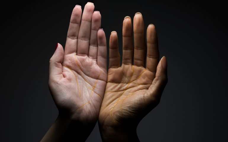 Two hands with lines picked in gold