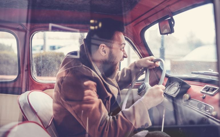 Furious Male Driving Fast with Old Style Car and Screaming