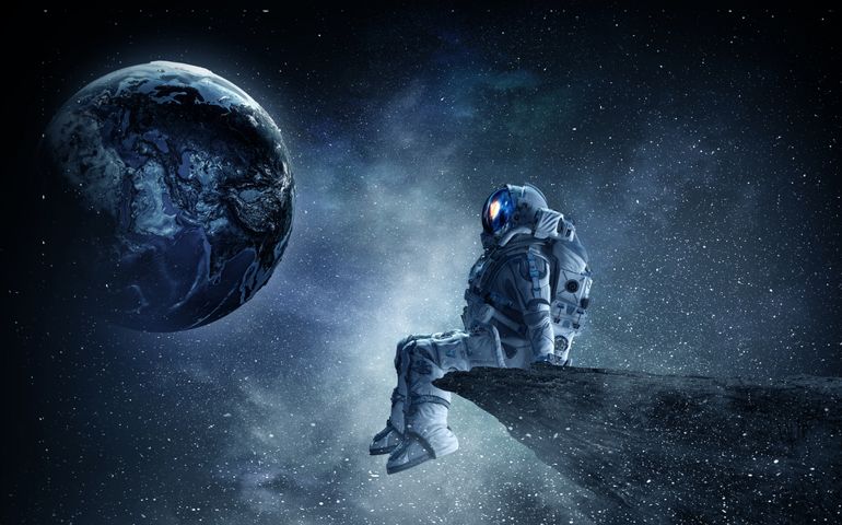Spaceman on rock edge