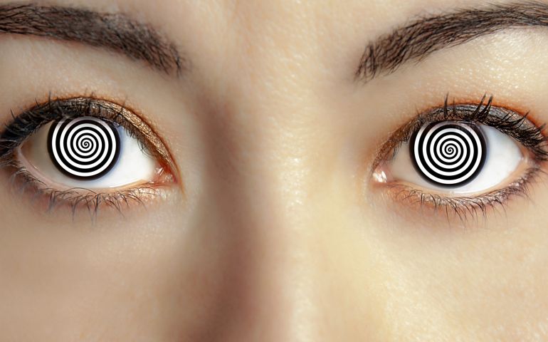 closeup woman face with hypnotized eyes