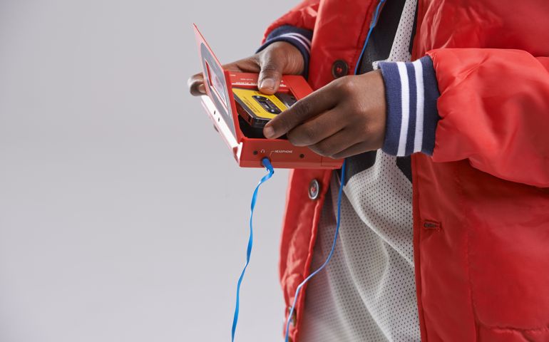 Cropped shot of a teen putting a cassete into a walkman