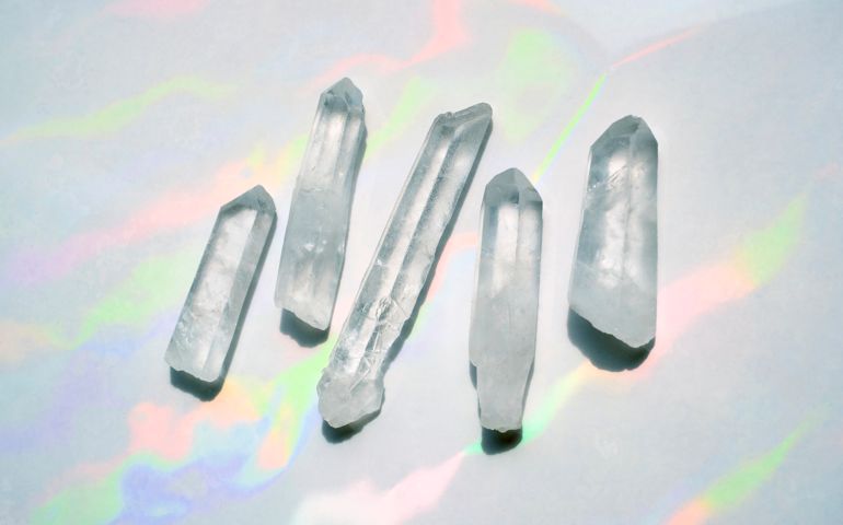 Transparent quartz crystals with rainbow light background