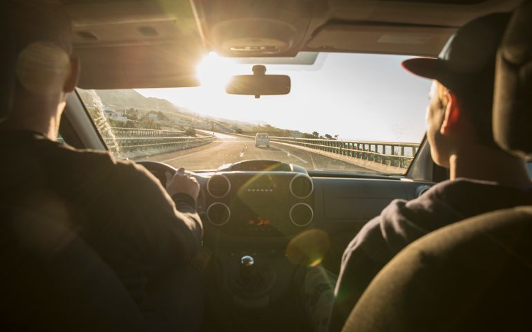 Father with son driving in car