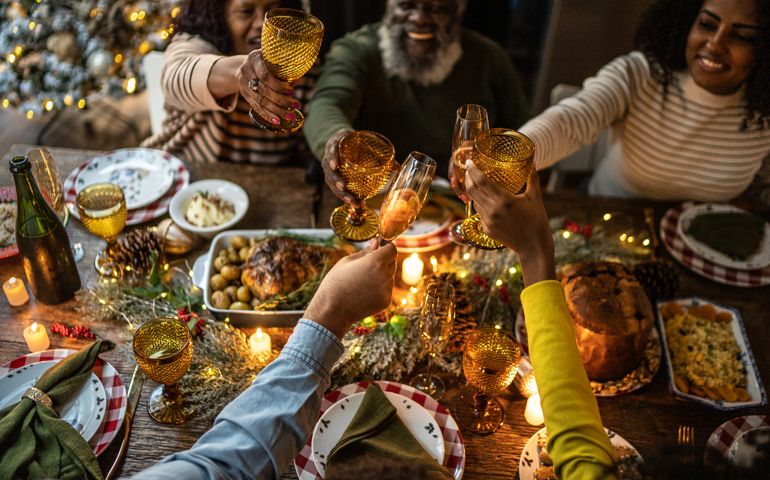 Family toasting on Christmas dinner at home