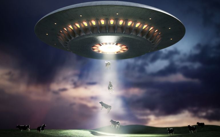 illustration of retro UFO hovering in the sky using a tractor beam on the cows
