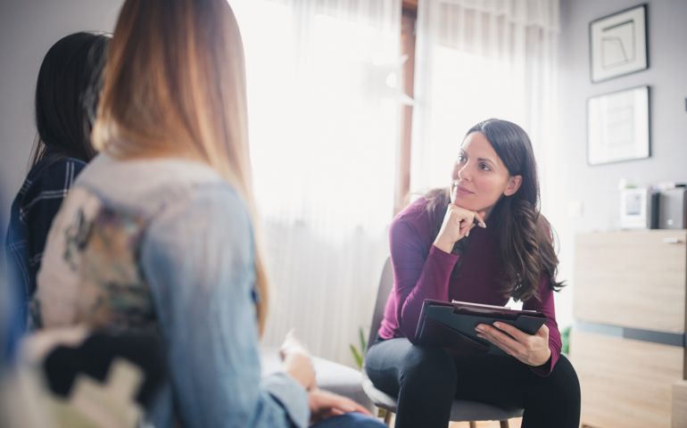 Counsellor advising young couple