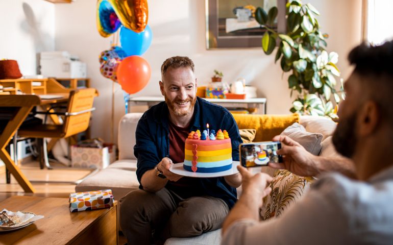 Close up of a young male couple celebrating a birthday and taking pictures