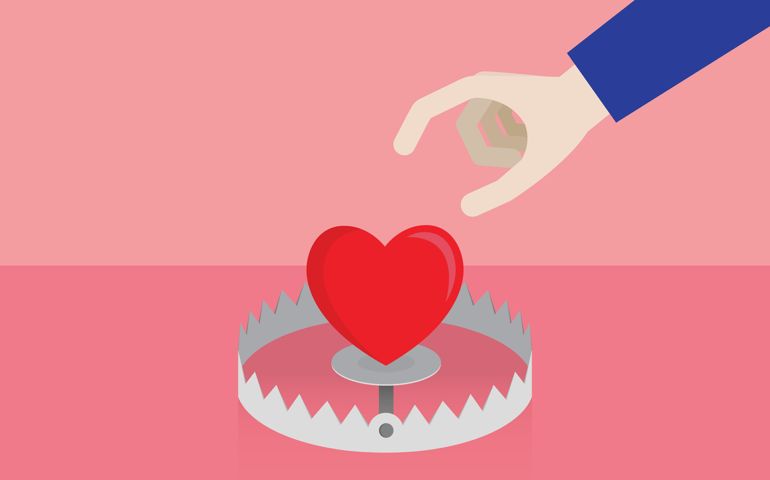 Hand picks up the heart from the trap