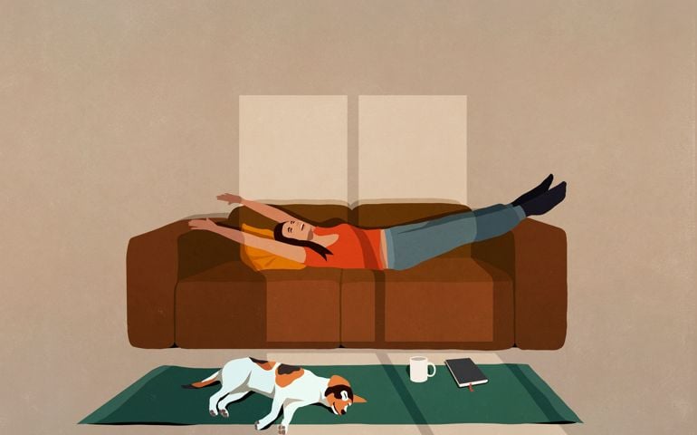 Carefree woman stretching on sofa in sunny living room