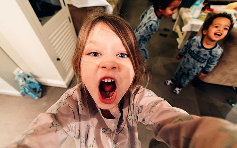 Selfie Of Little Girl Playing And Screaming In Mobile Phone - Happy Multiethnic Children In Pajamas