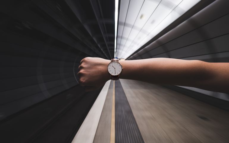 Cropped Image Of Woman Hand Showing Wristwatch At Subway Station