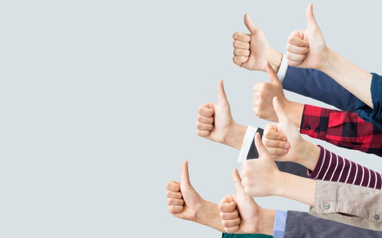 Hands making thumbs up