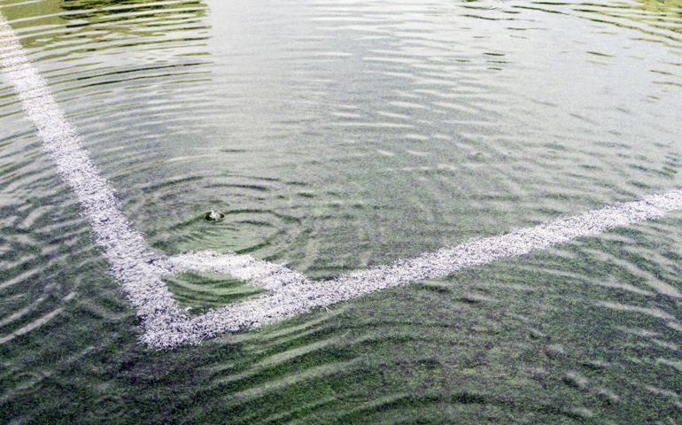 Flooding in artificial grass football field. After heavy rain
