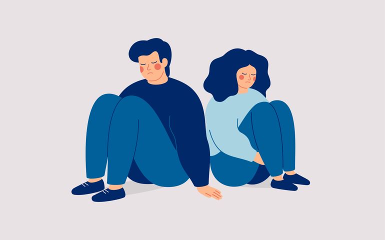 Sad man and woman sit back to back and no speak. Couple on the brink of divorce.