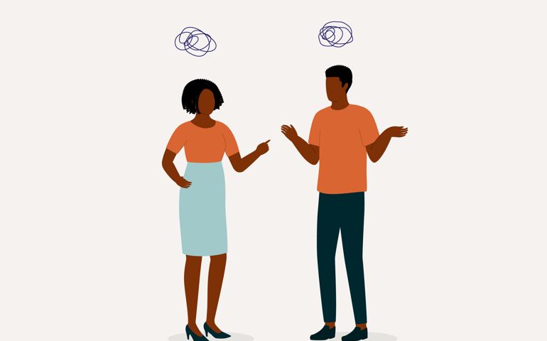 Angry Wife Blaming Her Husband With Finger Pointing At Him While Husband Acted Innocent With Shrugging Shoulders.