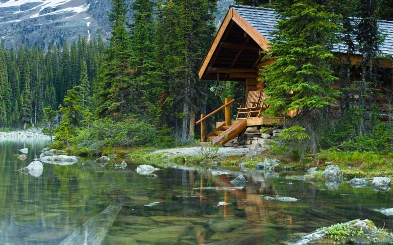 Log cabin hidden in the trees by the Lake Ohara in Canada