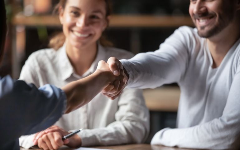 manager shake hands with applicant successfully passed job interview