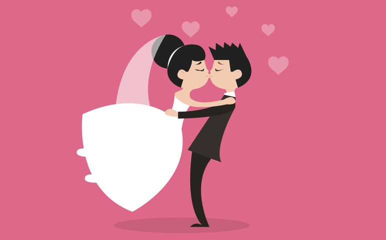 Wedding concept. Woman in white gown dress man in black suit couple, bride and groom dancing and kissing isolated on pink background.