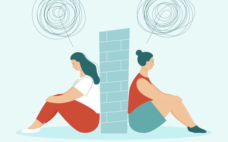 Two sad women in quarrel sitting back to back. Between them wall. Concept of problems in partnership, and love relationships.