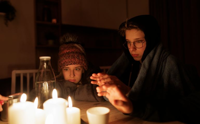 Family sitting by the candles during the blackout.