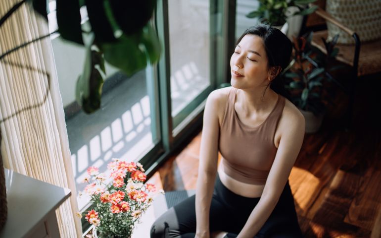 Active young woman taking a break after working out at home