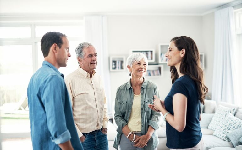 Shot of a young couple and their elderly parent spending some time together at home