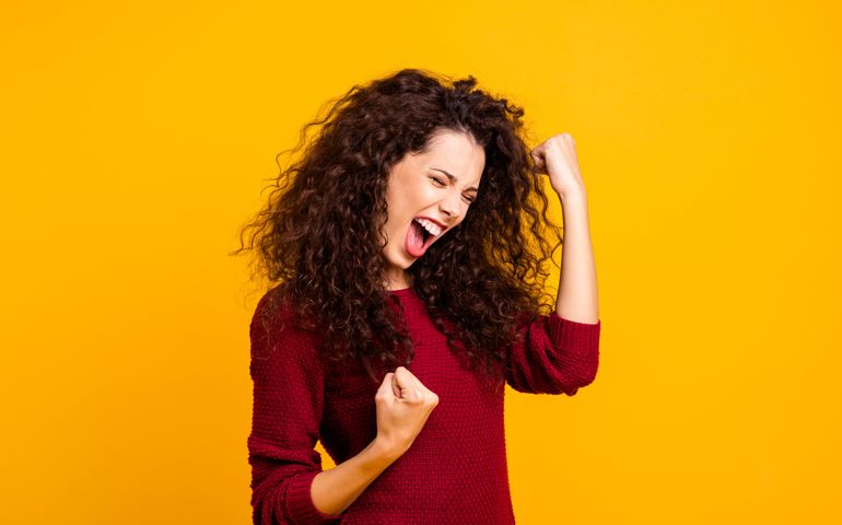 Close up photo amazing beautiful her she lady yelling voice raised fists eyes closed in delight emotional high spirits mood wearing red knitted sweater clothes outfit isolated yellow background