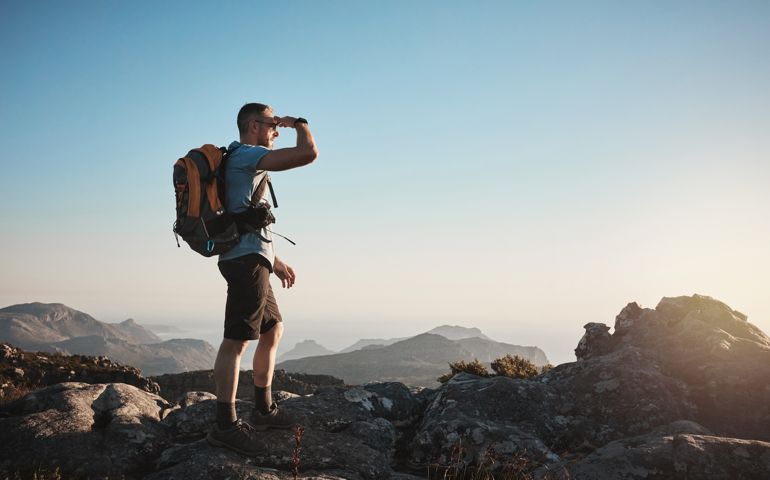 Shot of a mature man hiking up a mountain
