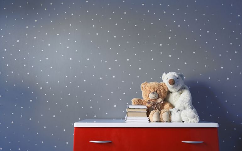 cute toy teddy bear and books on the table