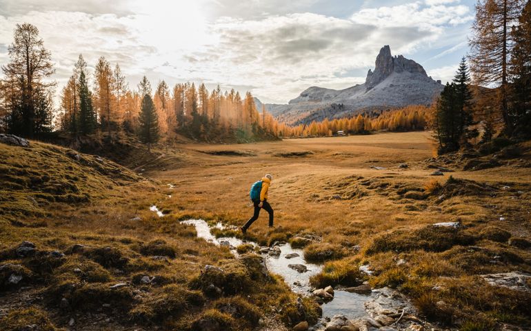 Solo Hiker Walking On A High Mountain Plain