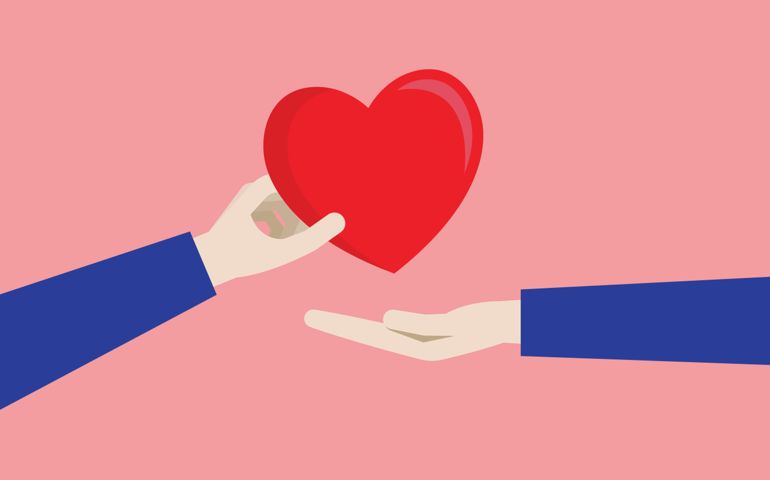 A couple gives a red heart