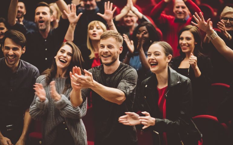 Happy audience applauding in the theater
