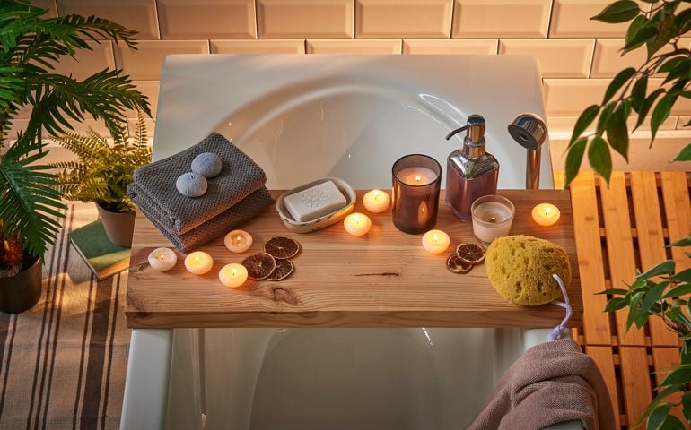 Modern bath room and spa center on the white tub wooden table.