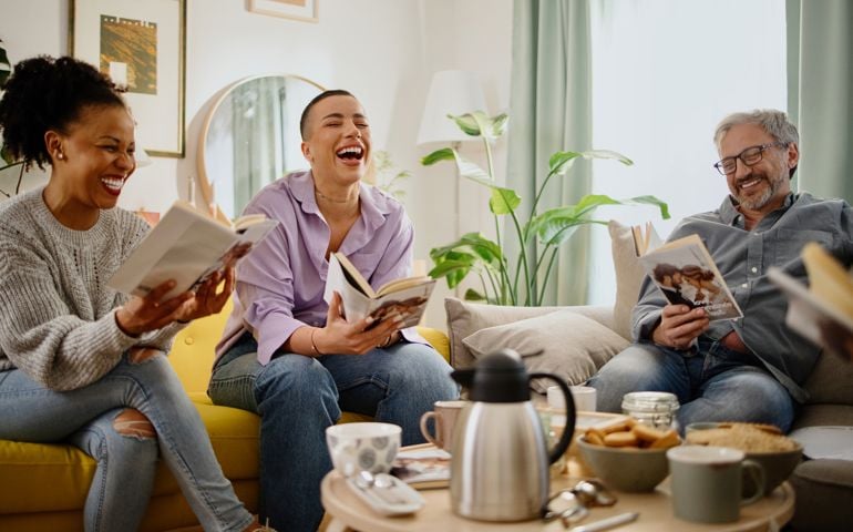 Small group of people with a mixed age range talking during a book club meeting.