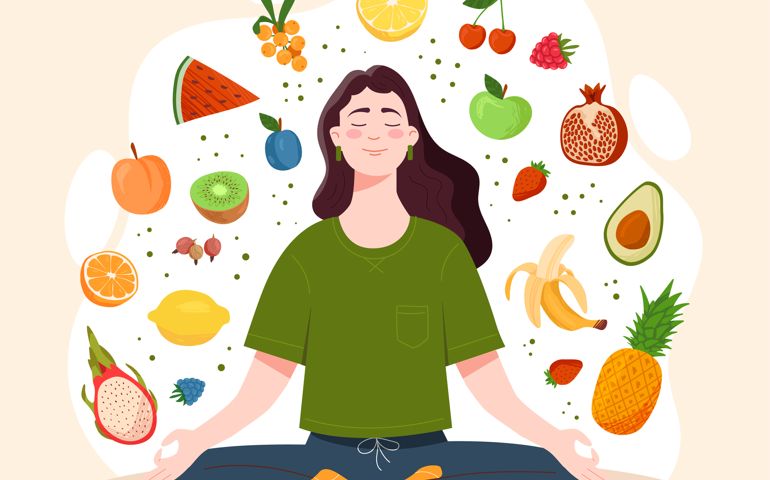 Mindful eating concept. Young woman, surrounded by tasty and healthy vegetables and fruits, sits in lotus position.