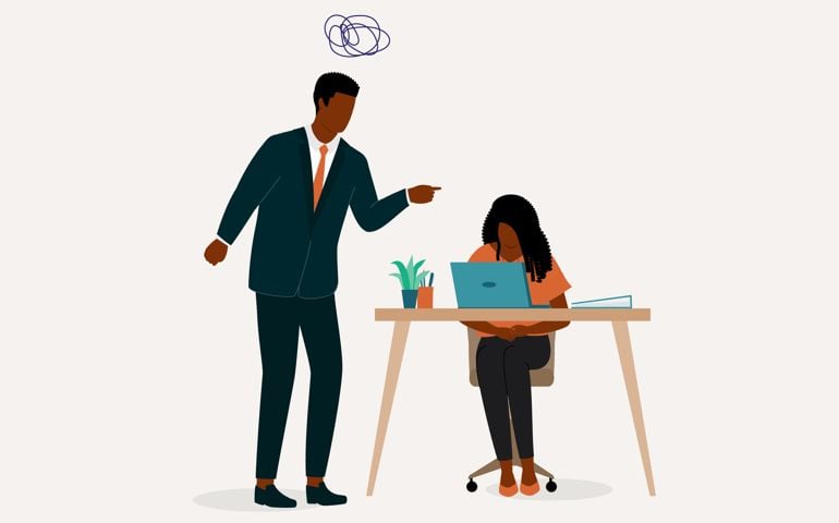 Angry Black Male Boss Scolding His Employee. Stressful Employee Sitting At Her Working Desk With Face Looking Down. Isolated On Color Background.