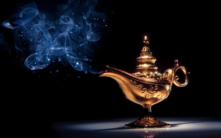 A gold genie lamp with smoke on black background