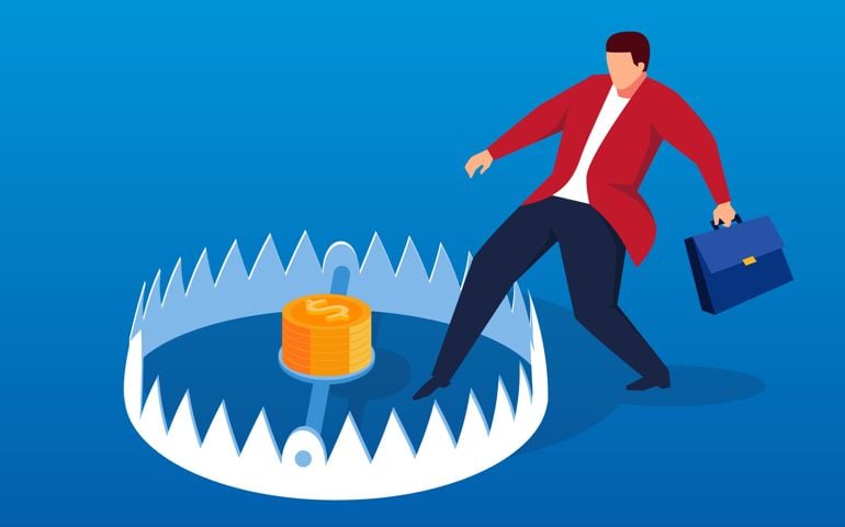 Businessman carefully enters mouse trap