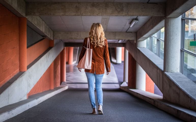 Stylish blond hair woman wearing corduroy jacket and jeans.
