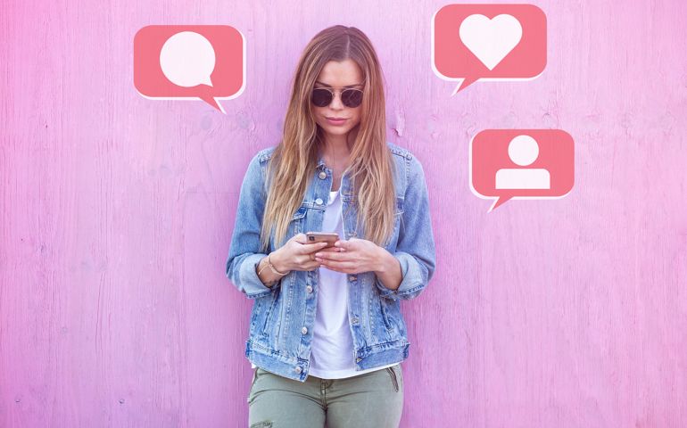 Beauty Girl Influencer Using Social Media on Smartphone with Like, Comment, Follower icon Around on Pink Background