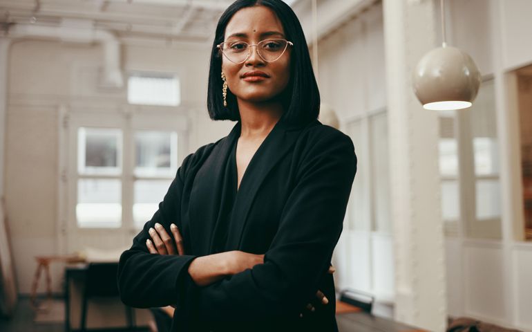 Portrait of a confident young businesswoman working in a modern office