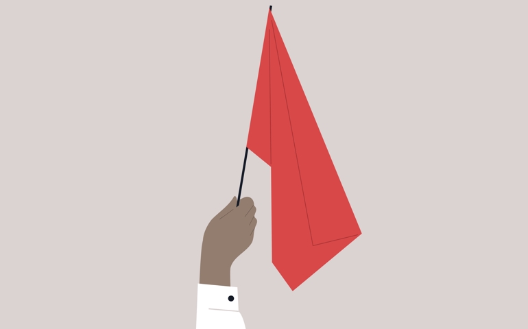 A hand waving a red flag, a warning sign