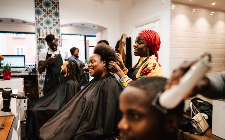hair expertise making hairstyle of male and female customers at barber shop
