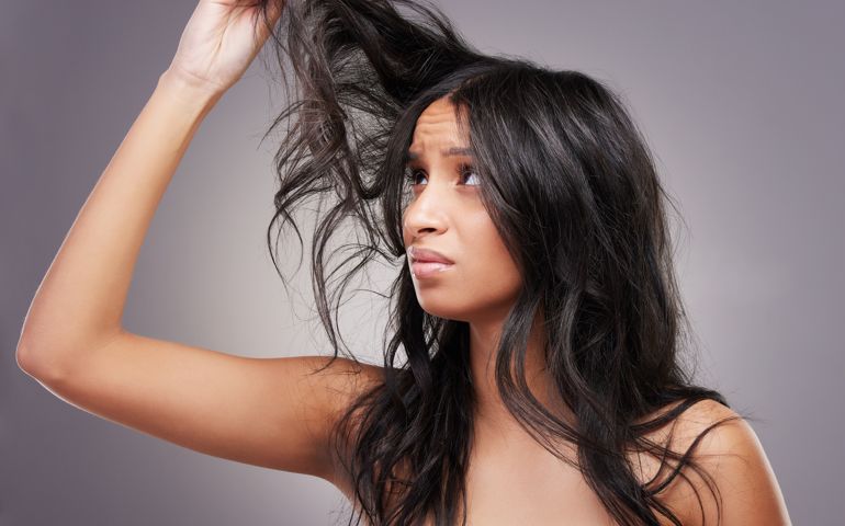 Shot of an attractive young woman standing alone in the studio and feeling stressed