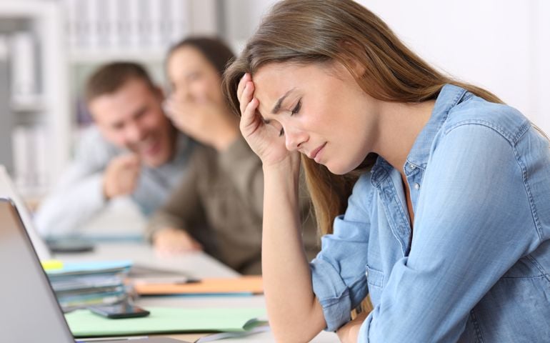 Side view portrait of a bullying victim being criticized at office