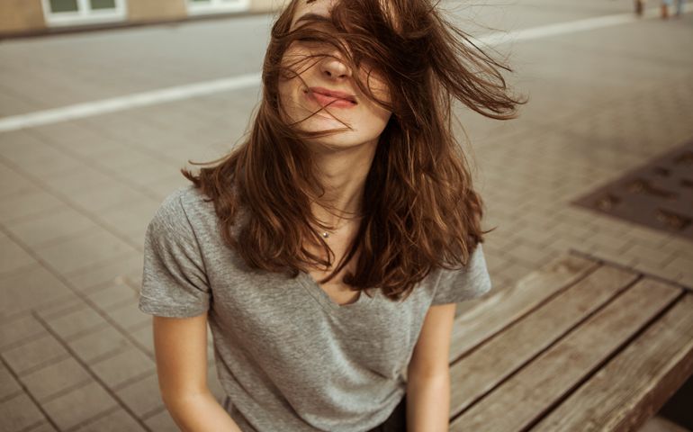 Young woman outdoors with windswept hair
