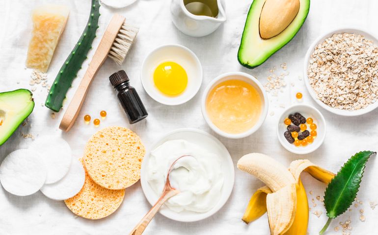 Winter skin care. Homemade natural ingredients for a nourishing face mask on a light background, top view.