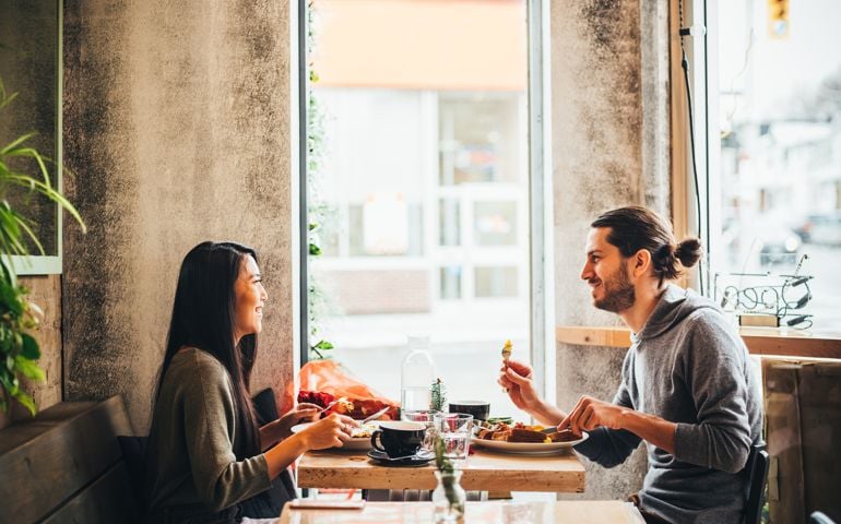 Young couple on a date at the Bistro restaurant on Valentine's Day holiday.
