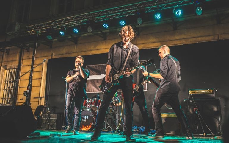 Young music band performing at rock concert